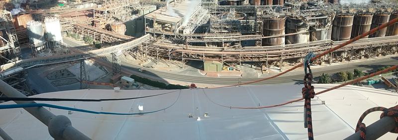 Wide view of rope access rigging set up high above a mineral processing plant